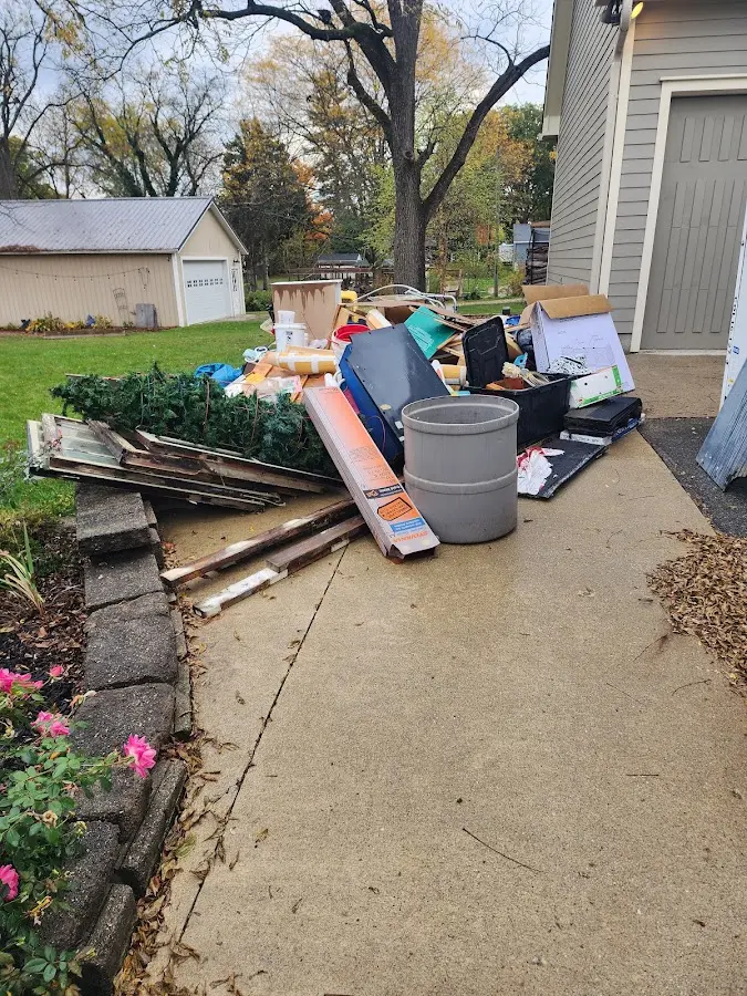 Dumpster being loaded with debris for Estate Cleanout Dumpster Rental in Fox River Grove